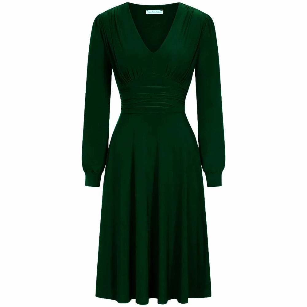 A red long sleeve ruched deep V-neck dress with a knee-length skirt.